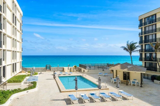 a view of a swimming pool with an outdoor seating