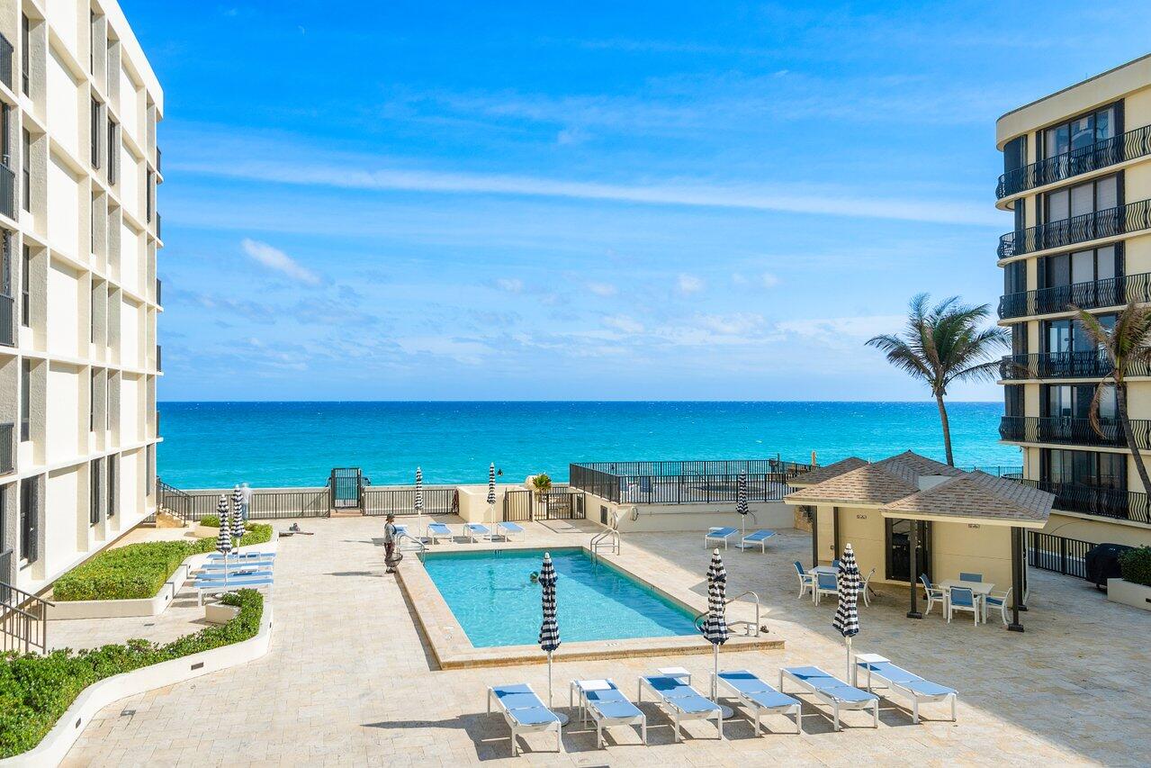 3610 South Ocean Boulevard, Unit 502 South Palm Beach, FL 33480 - Photo 8 of 51 a view of a swimming pool with an outdoor seating