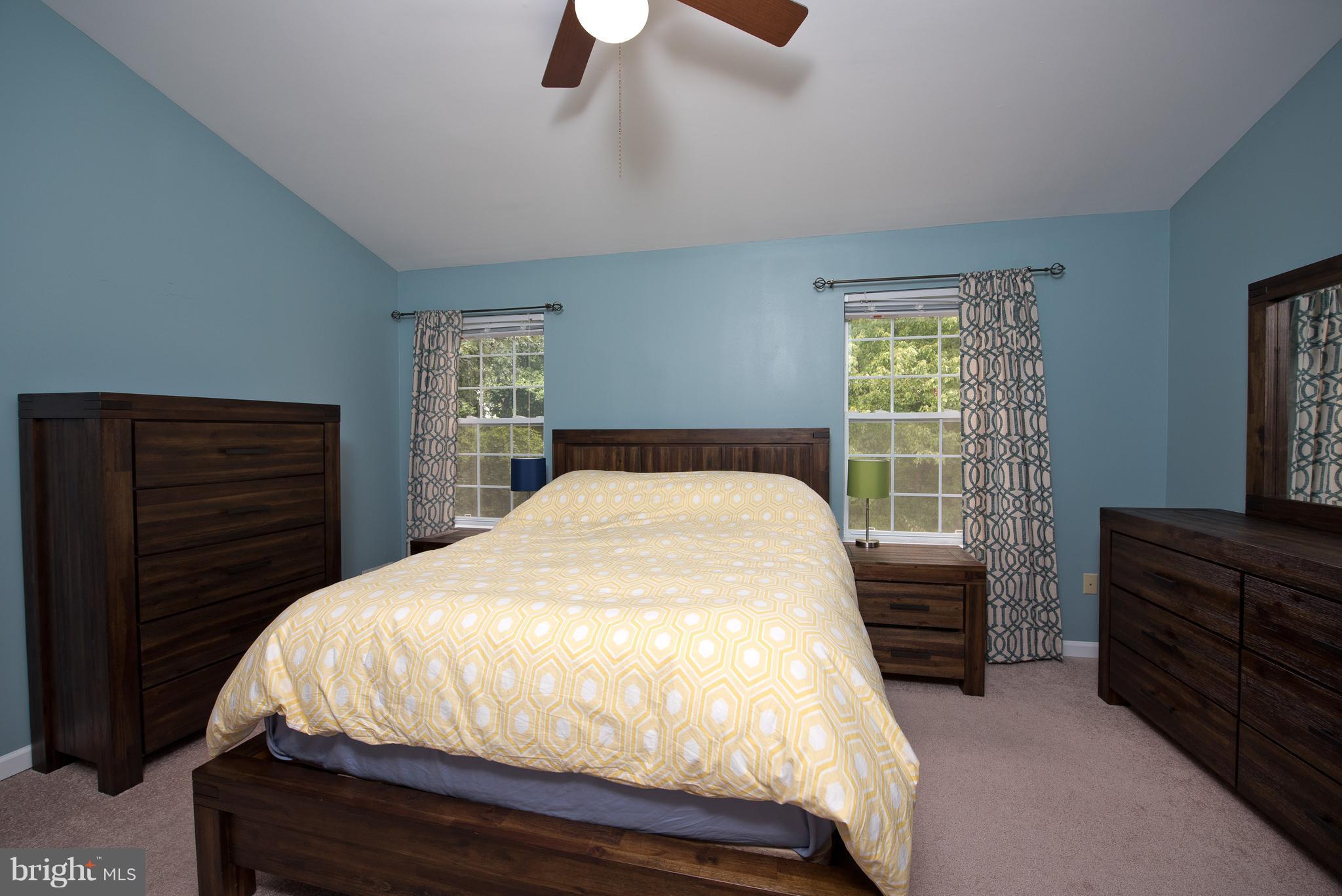 6163 Good Hunters Ride Columbia, MD 21045 - Photo 13 of 30 a bedroom with a bed and a flat tv screen