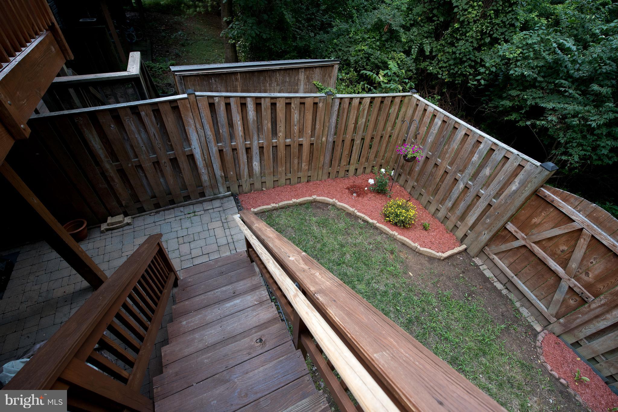 6163 Good Hunters Ride Columbia, MD 21045 - Photo 28 of 30 a view of deck with wooden floor and fence with a garden