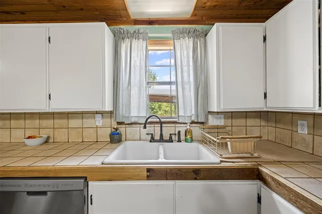 a kitchen with a sink and cabinets