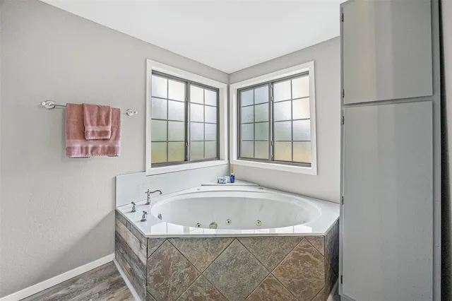 a white bath tub sitting next to a window
