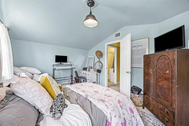 a bedroom with a bed and flat screen tv