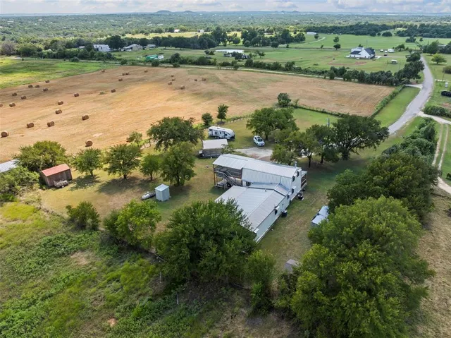 an aerial view of a house with lake view