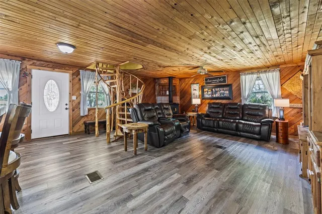 a living room with furniture and wooden floors