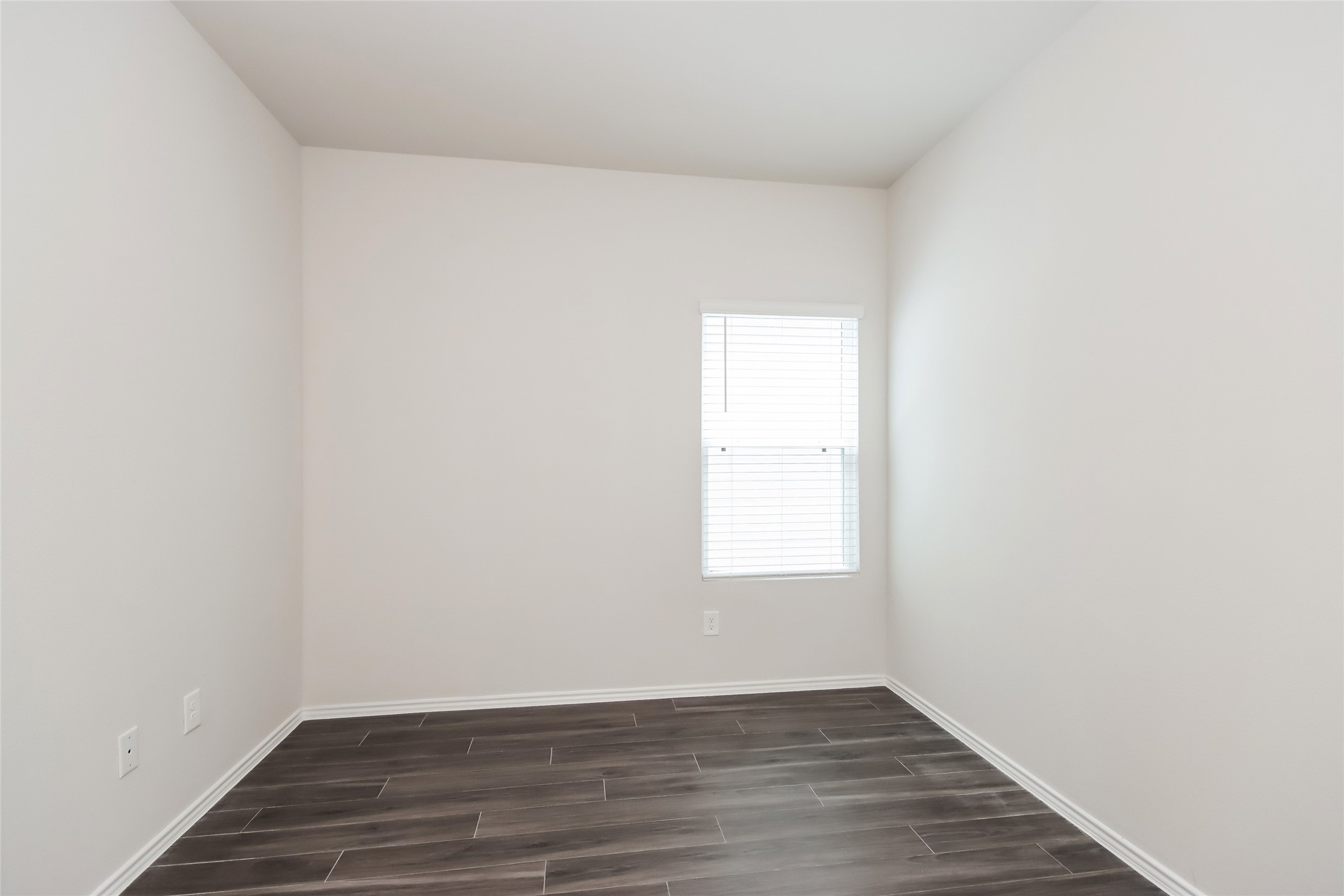15264 Estrella Road East Houston, TX 77073 - Photo 13 of 14 an empty room with wooden floor and window