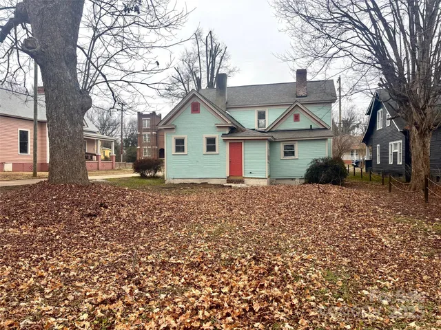a front view of house with yard and trees