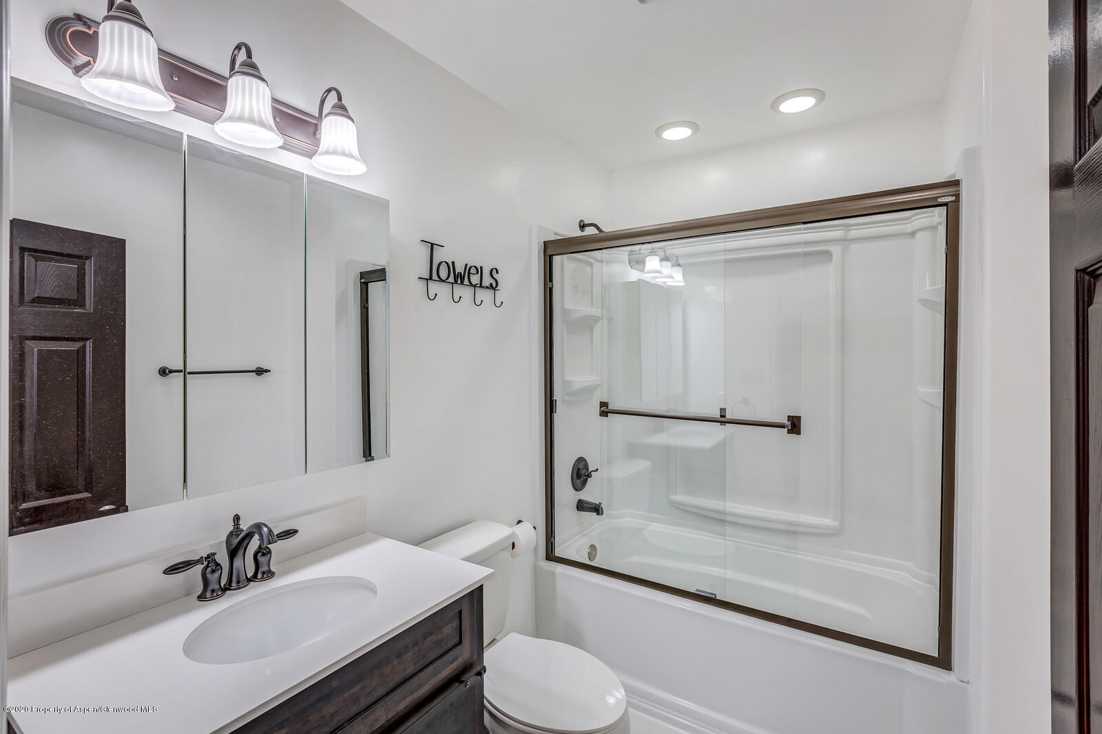 216 West 4th Street Rifle, CO 81650 - Photo 14 of 17 a bathroom with a shower sink vanity mirror and toilet