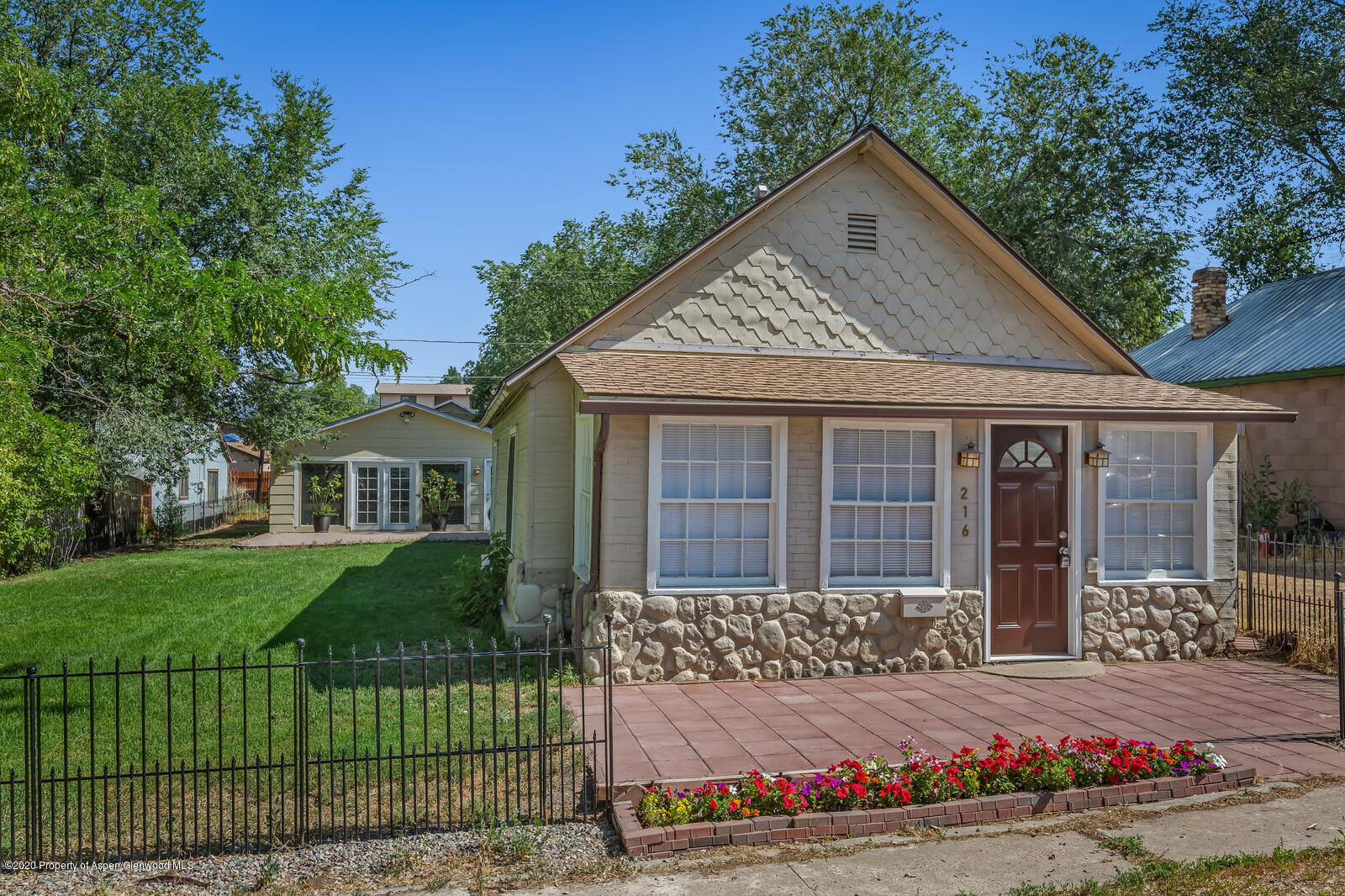 216 West 4th Street Rifle, CO 81650 - Photo 2 of 17 a front view of a house with a garden