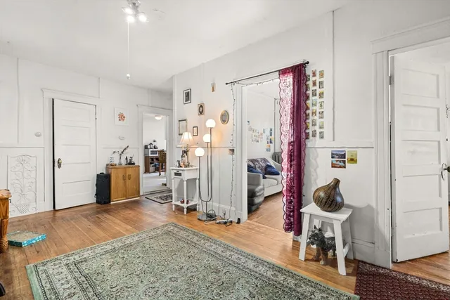 a living room with furniture rug and wooden floor