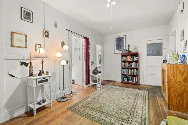 a view of a livingroom with furniture and an empty room
