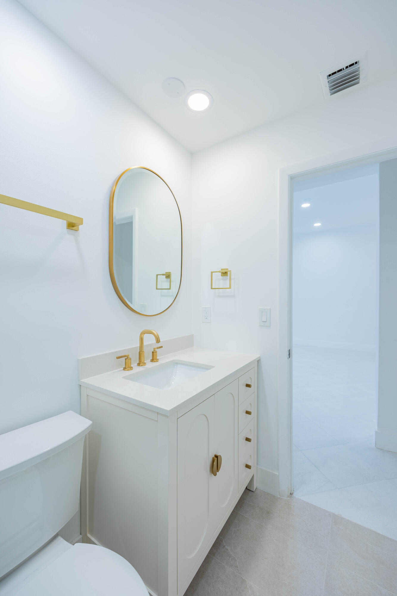 7520 La Paz Boulevard, Unit 104 Boca Raton, FL 33433 - Photo 37 of 56 a bathroom with a sink mirror and toilet