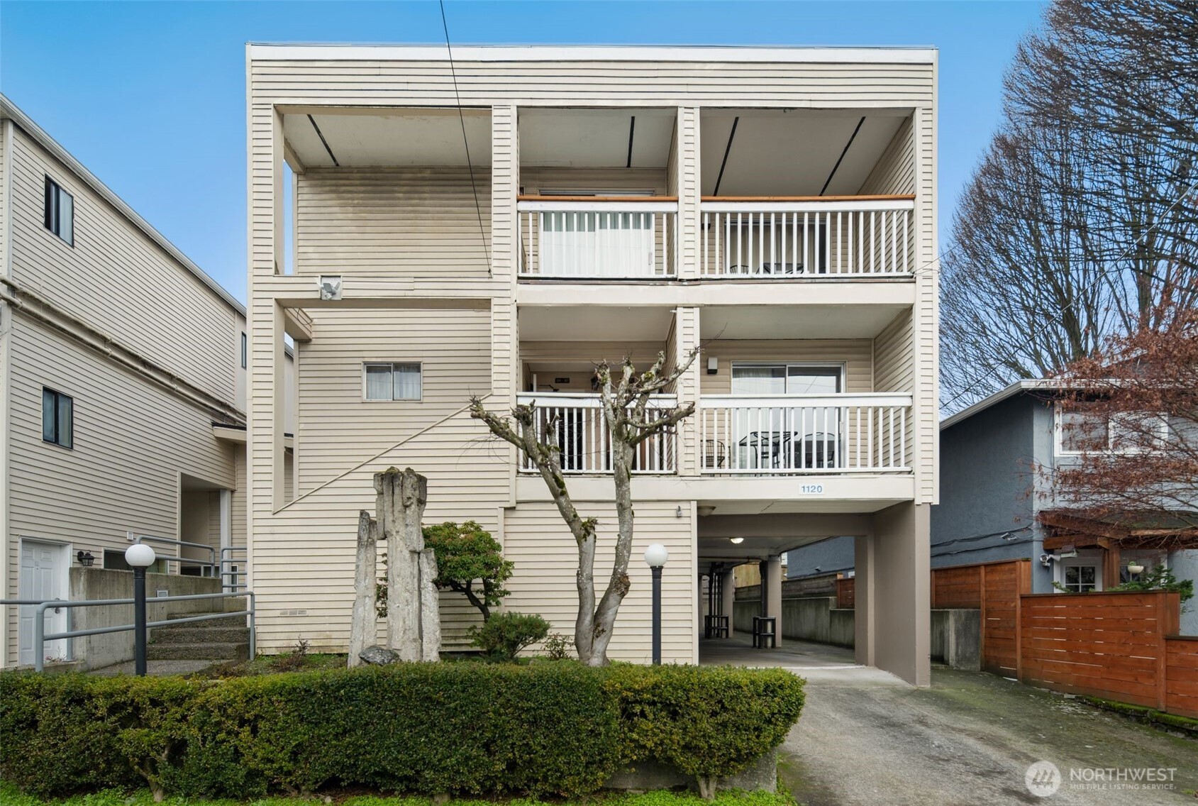 a view of a house with large windows and a small yard