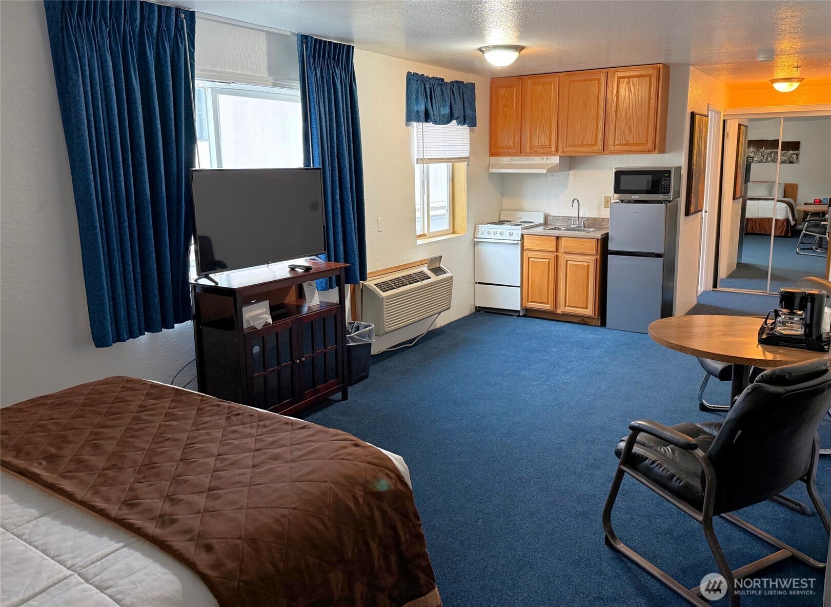 1120 North 91st Street Seattle, WA 98103 - Photo 13 of 23 a kitchen with stainless steel appliances kitchen island hardwood floor sink stove and refrigerator