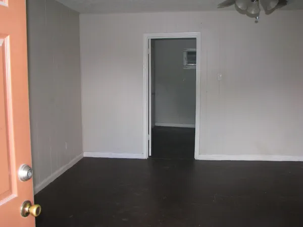 an empty room with wooden floor