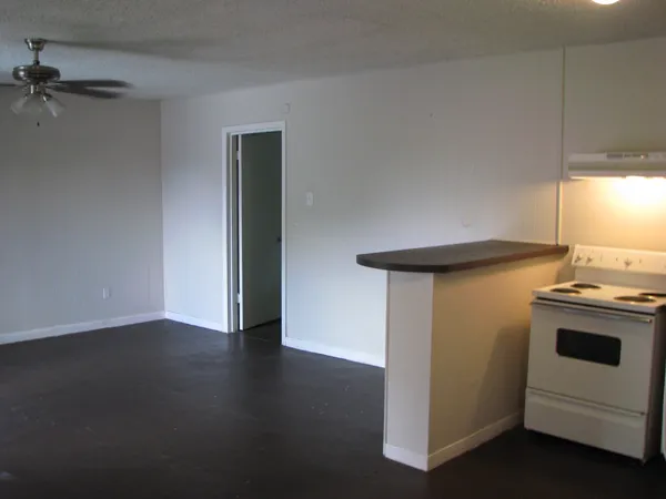 a view of a kitchen with a stove cabinets and a wooden floor