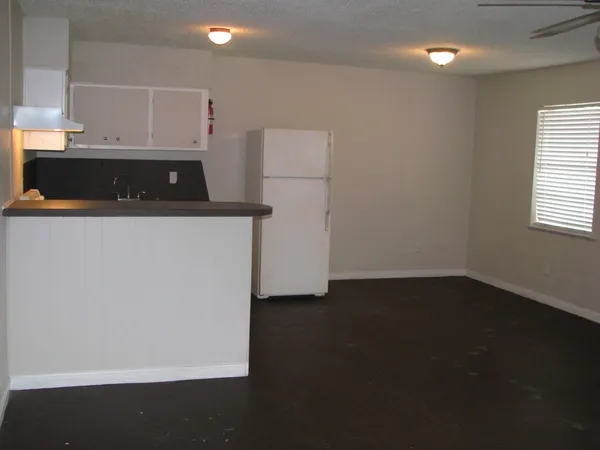 a kitchen with a refrigerator and a stove