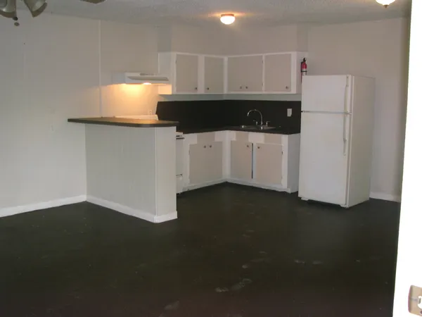 a kitchen with a refrigerator and a stove