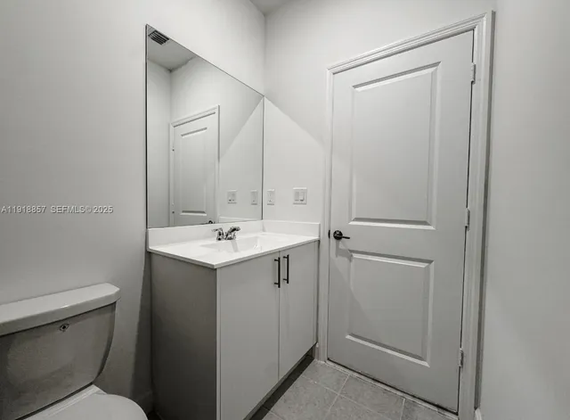 a bathroom with a sink toilet and vanity