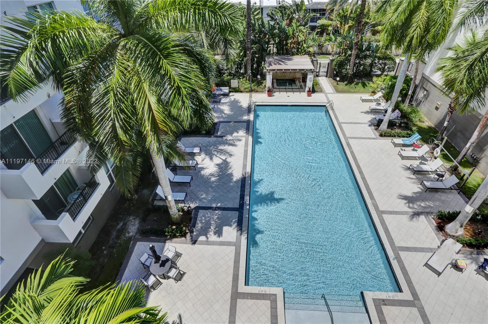 a balcony with furniture and a potted plant