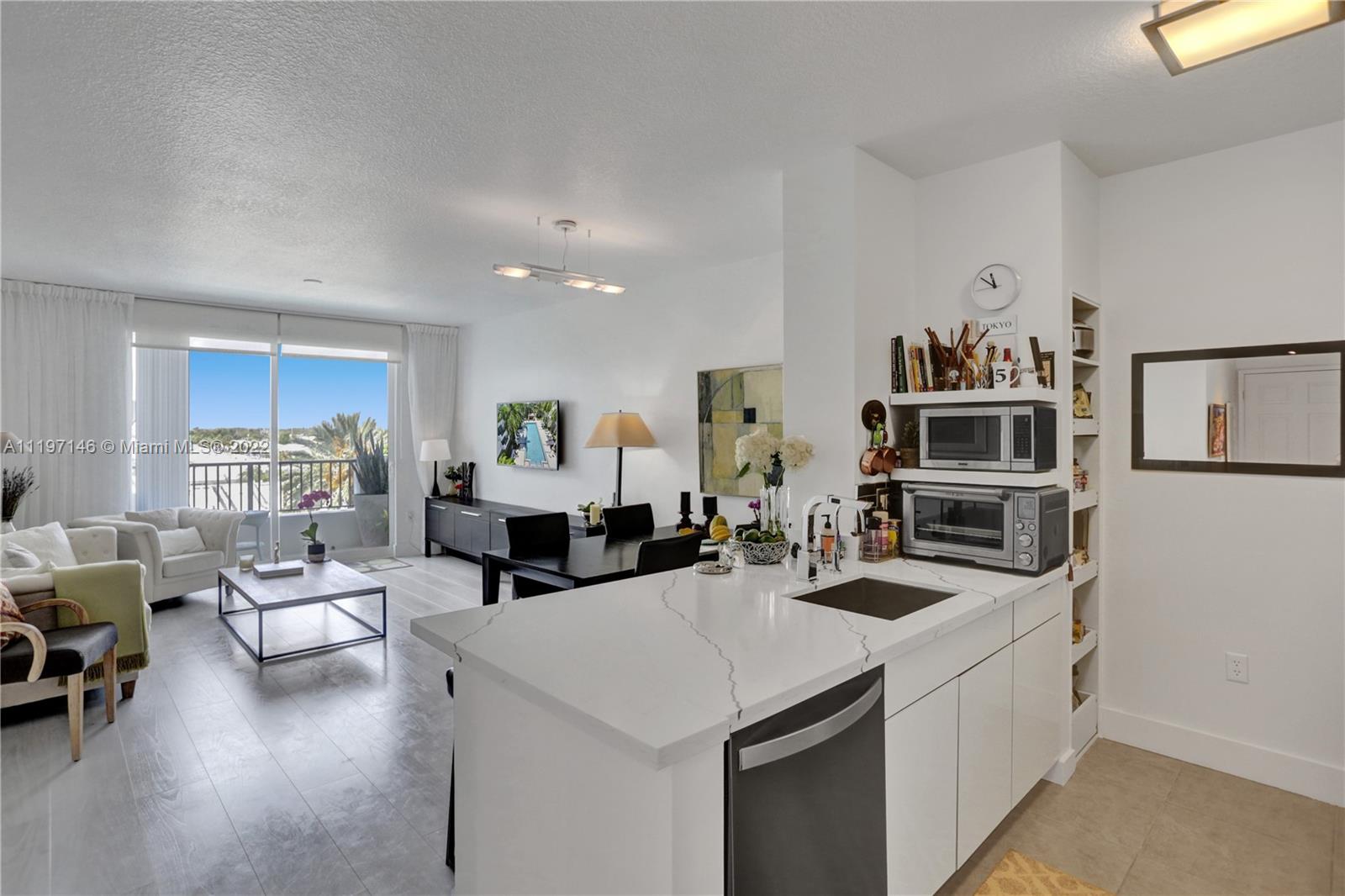 Imperial Point Fort Lauderdale, FL 33308 - Photo 17 of 37 a living room with furniture a flat screen tv and kitchen view