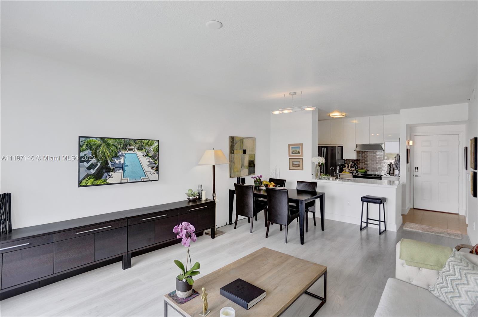 Imperial Point Fort Lauderdale, FL 33308 - Photo 19 of 37 a living room with furniture kitchen view and a dining table