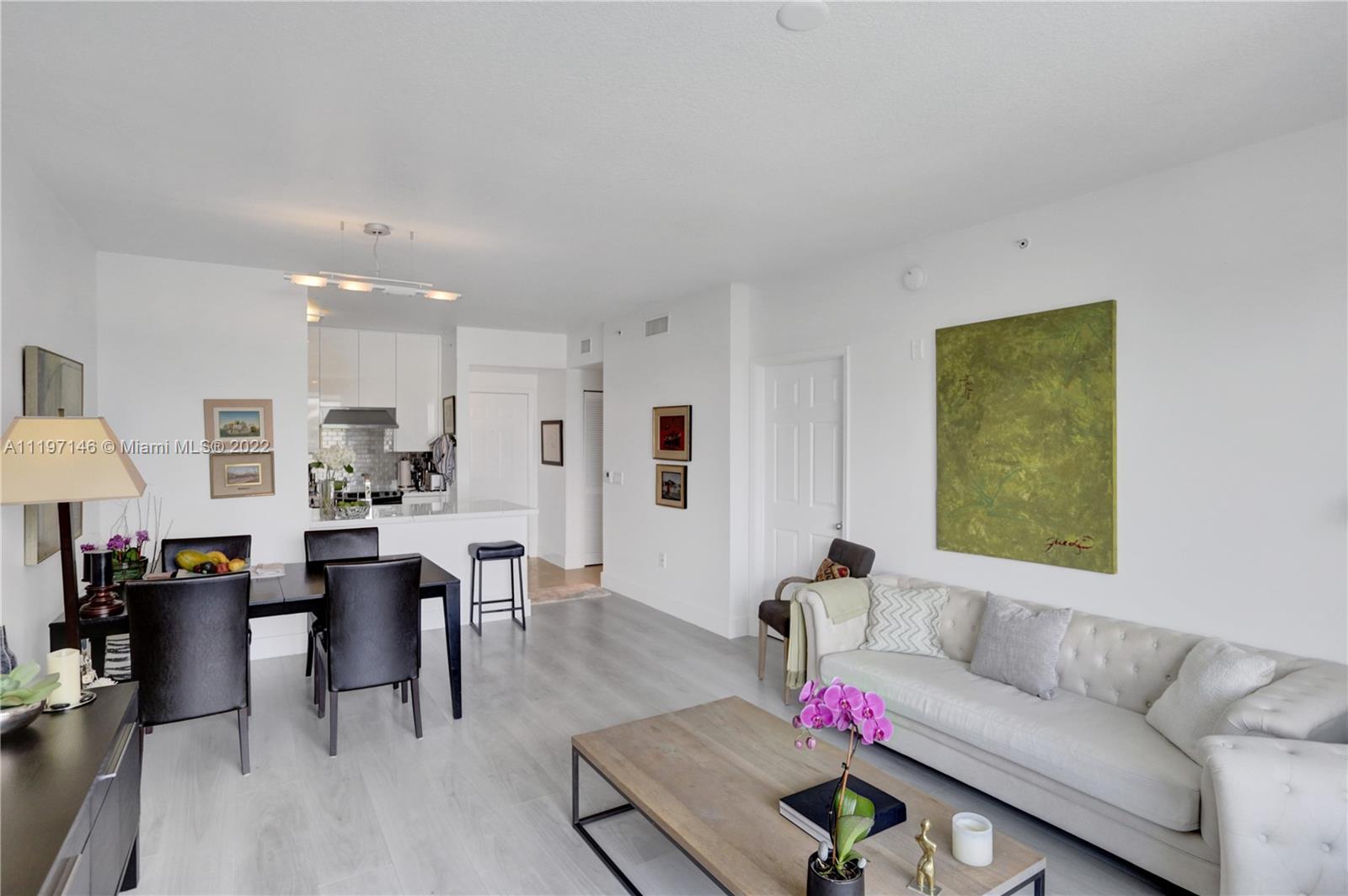 Imperial Point Fort Lauderdale, FL 33308 - Photo 20 of 37 a living room with furniture and a dining table with kitchen view