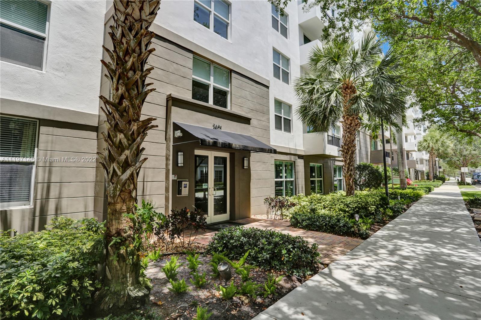 Imperial Point Fort Lauderdale, FL 33308 - Photo 36 of 37 a front view of a multi story residential apartment building with yard and green space