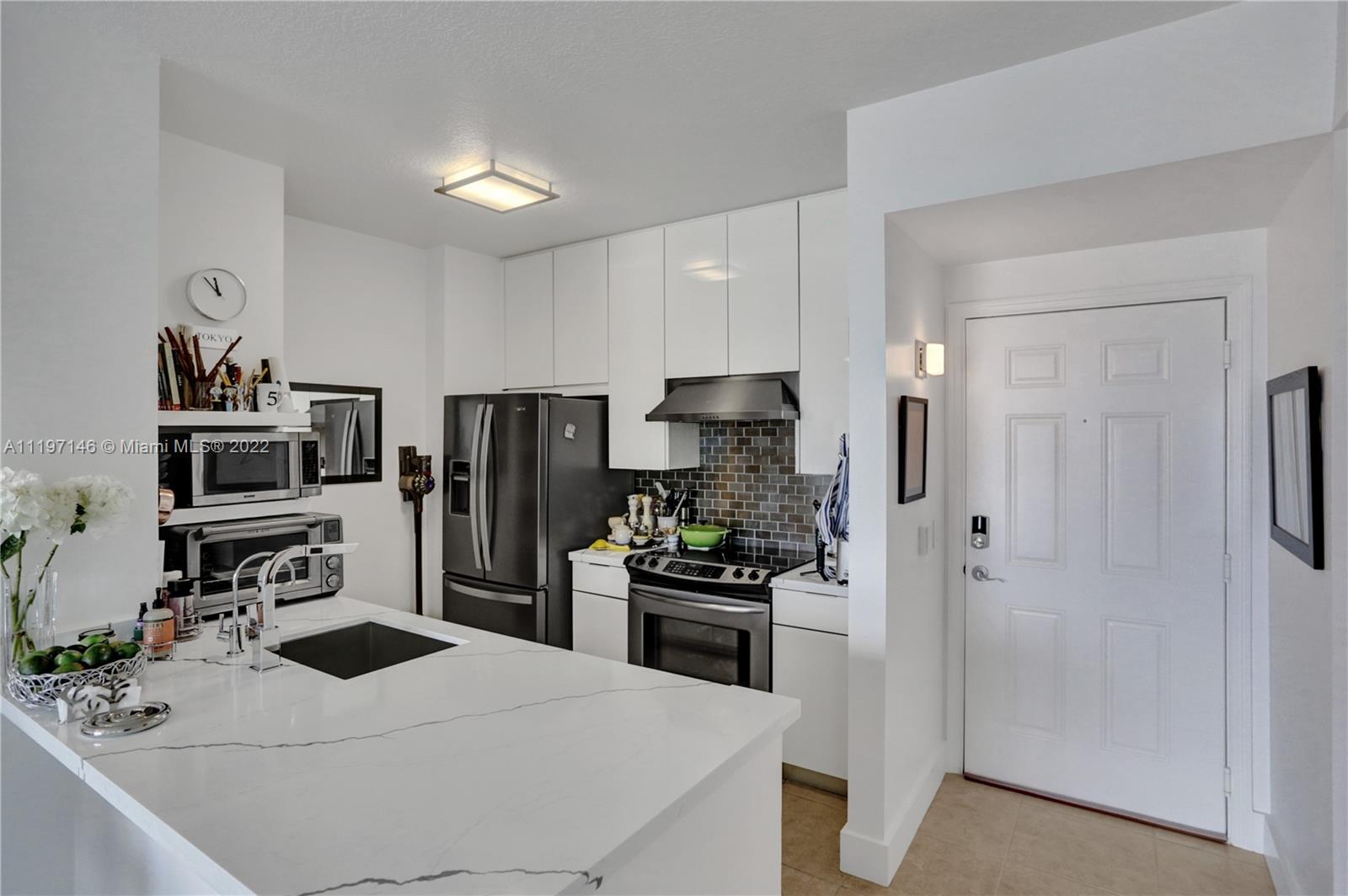 Imperial Point Fort Lauderdale, FL 33308 - Photo 4 of 37 a kitchen with a refrigerator and a stove top oven