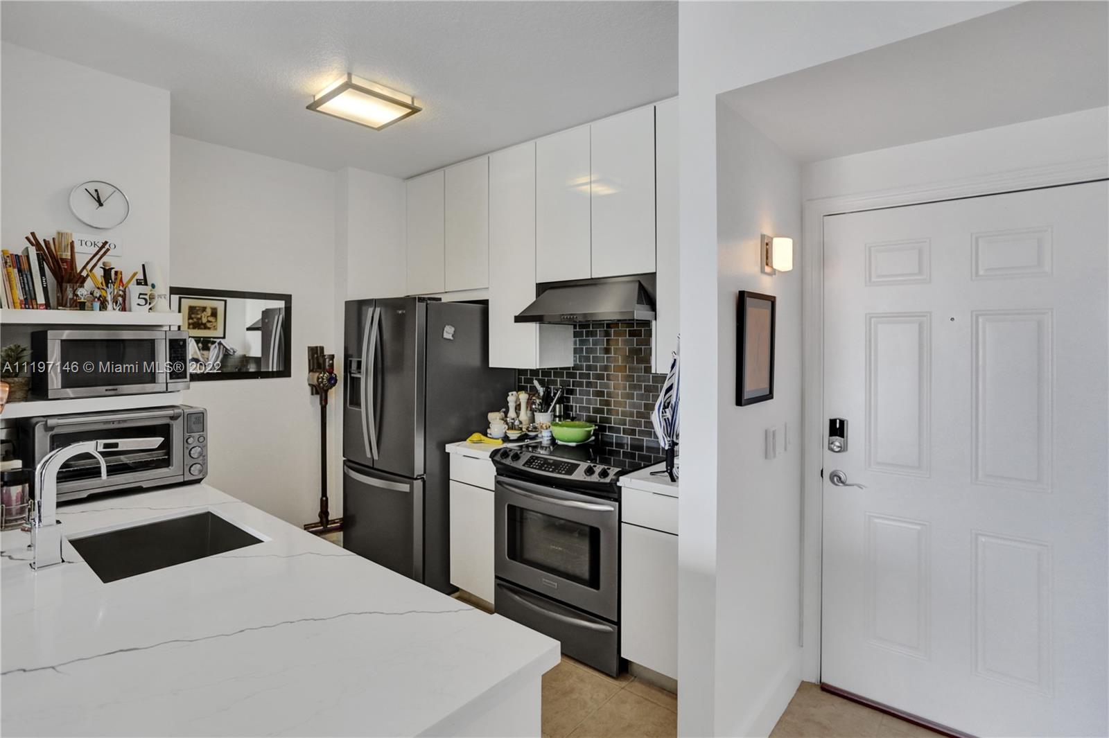 Imperial Point Fort Lauderdale, FL 33308 - Photo 6 of 37 a kitchen with stainless steel appliances kitchen island a refrigerator and a stove