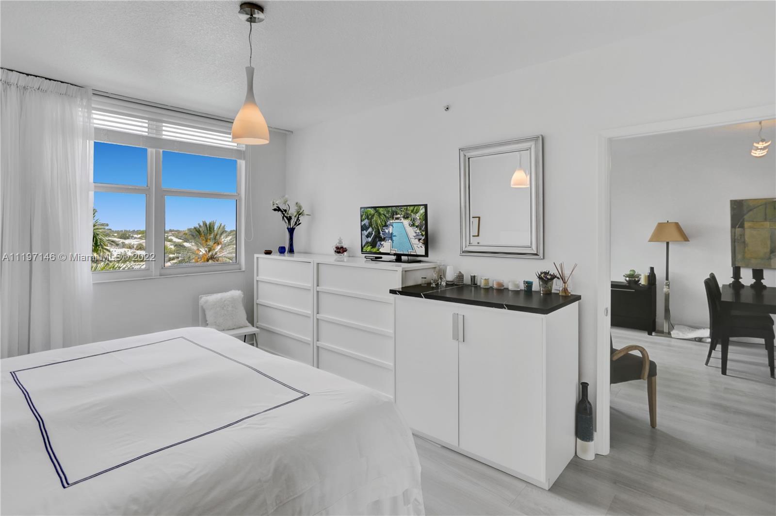 Imperial Point Fort Lauderdale, FL 33308 - Photo 10 of 37 a bedroom with a bed and a chandelier