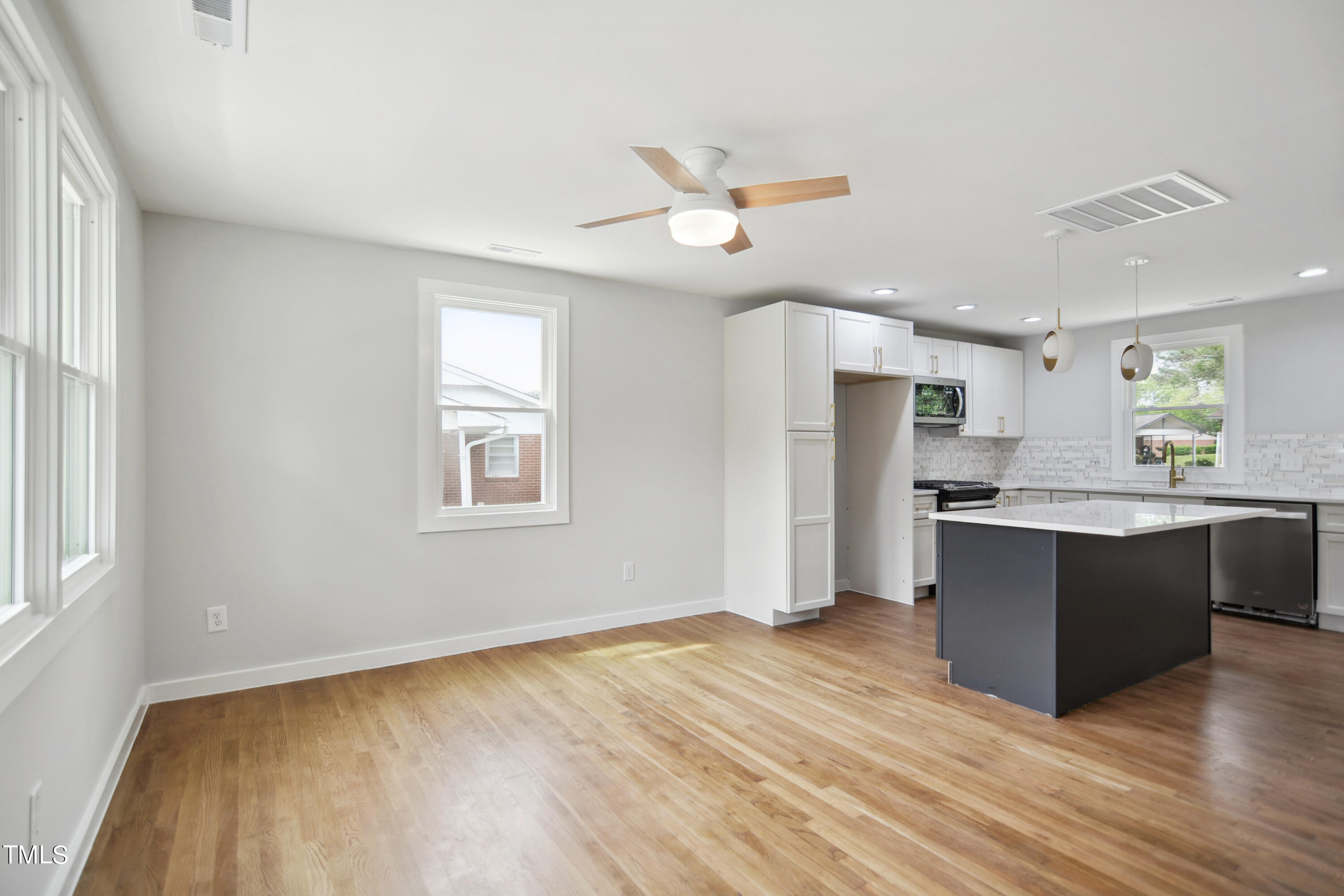 817 Newcombe Road Raleigh, NC 27610 - Photo 3 of 13 a view of kitchen with wooden floor and electronic window