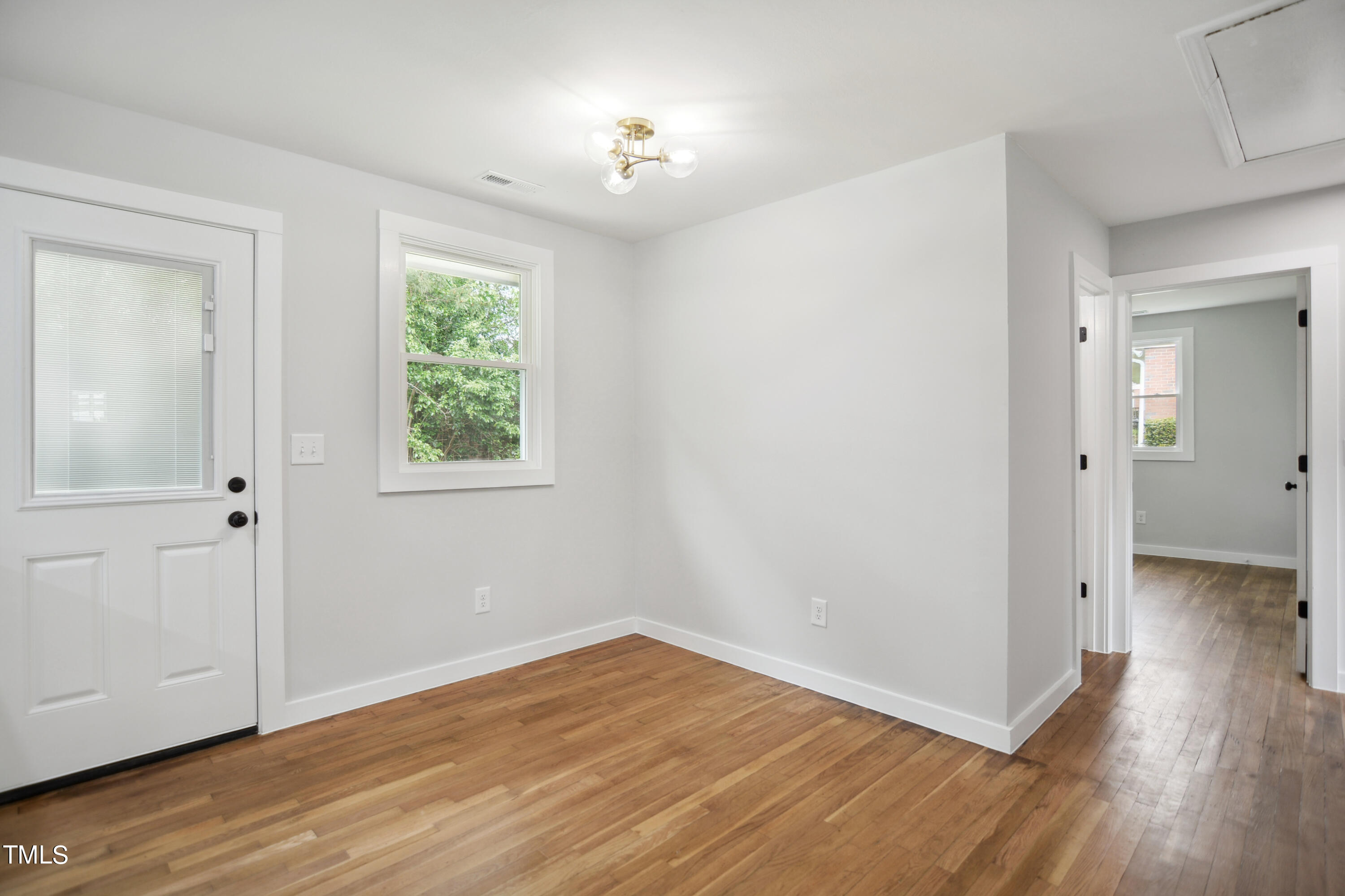817 Newcombe Road Raleigh, NC 27610 - Photo 8 of 13 a view of a room with wooden floor and a window