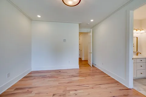 a view of a kitchen with kitchen island stainless steel appliances and a wooden floor