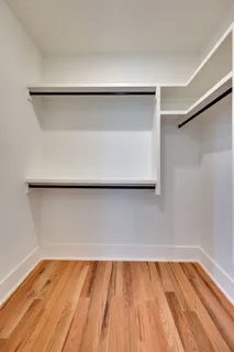 a large kitchen with stainless steel appliances granite countertop a large counter top a sink and a refrigerator