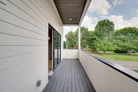 a view of a balcony with wooden floor