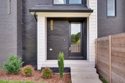 a view of a hallway with wooden floor and stairs