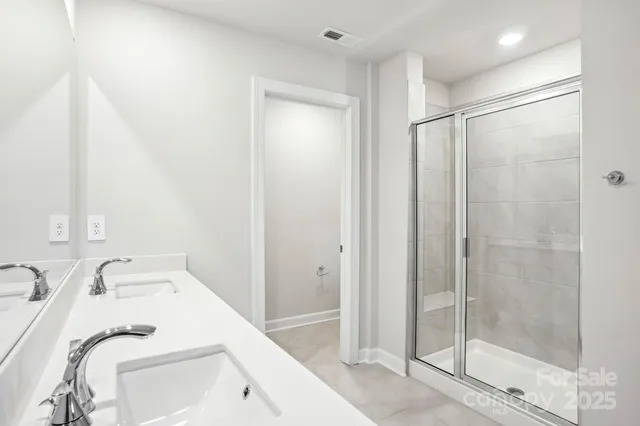 a bathroom with a sink a mirror and a shower