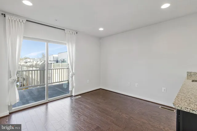 a view of wooden floor and windows in a room