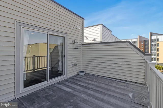 a view of a porch with a door and a balcony