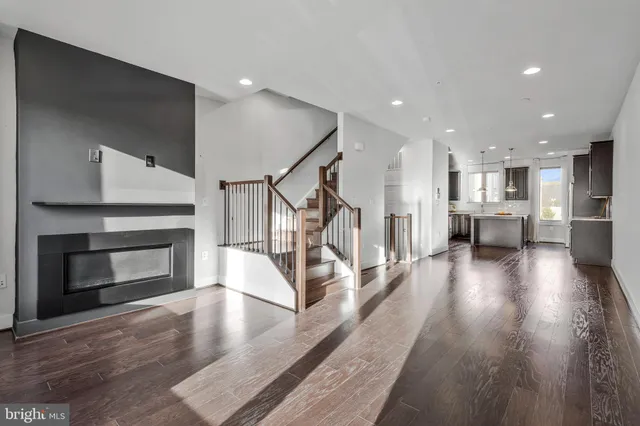 a view of a kitchen with furniture and wooden floor