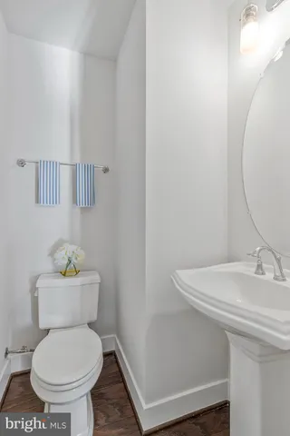 a white toilet sitting next to a bathroom sink