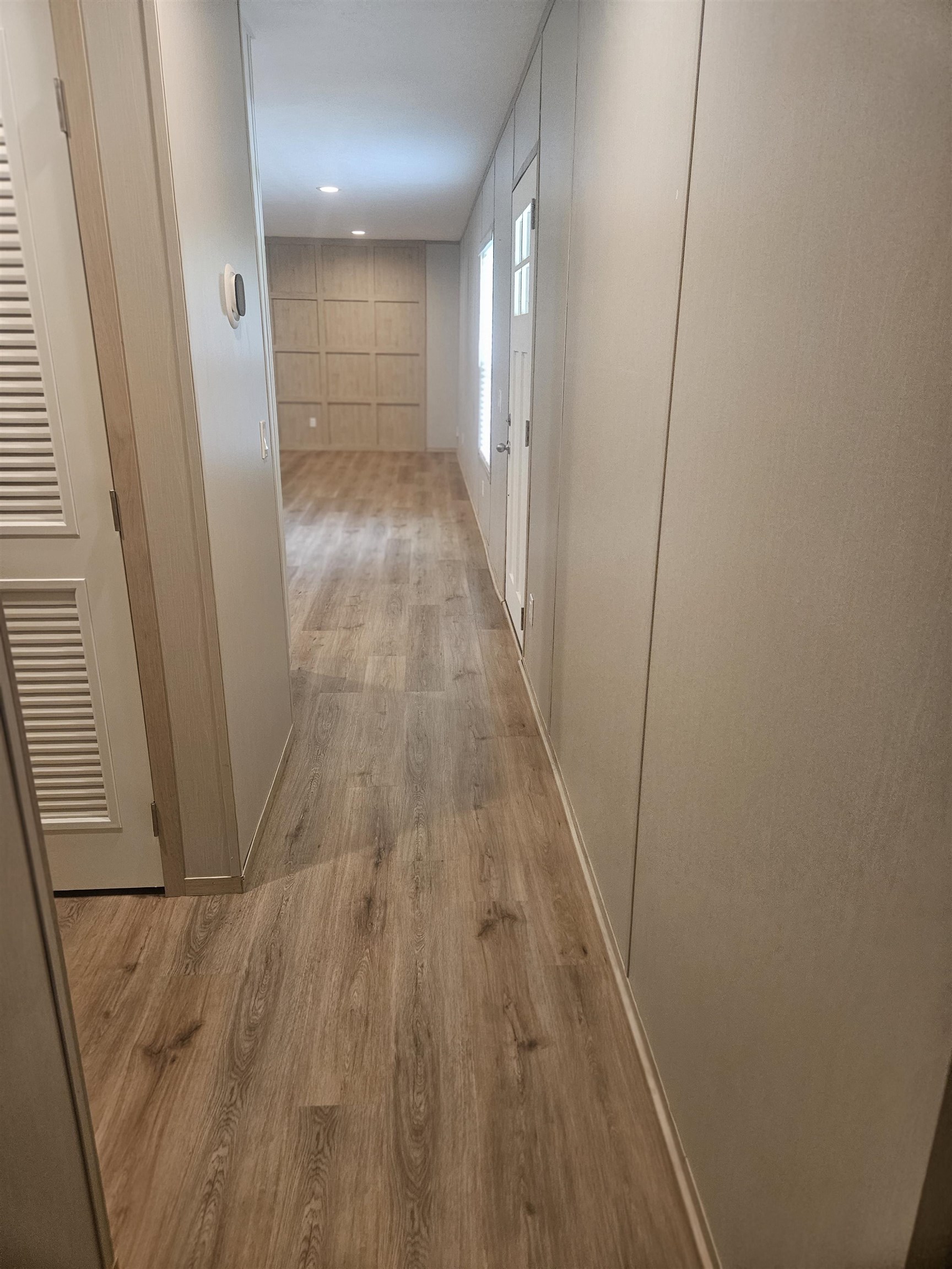 75 Pittman Road, Unit ROAD Somerville, TN 38068 - Photo 15 of 26 Hallway featuring wood-finish flooring, recessed lighting, and a paneled accent wall