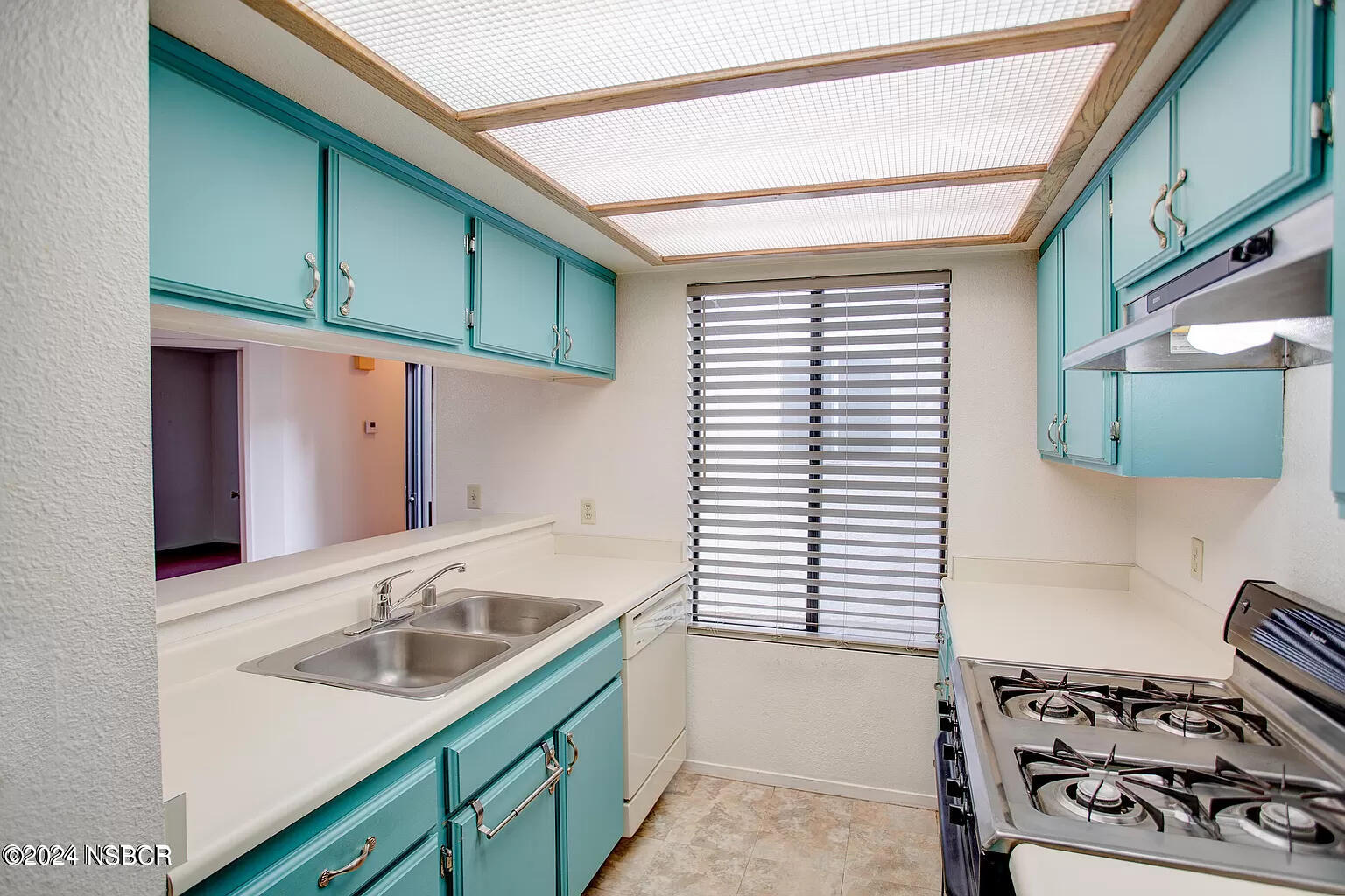 1352 Viola Way Lompoc, CA 93436 - Photo 13 of 30 a kitchen with a sink cabinets and a stove top oven