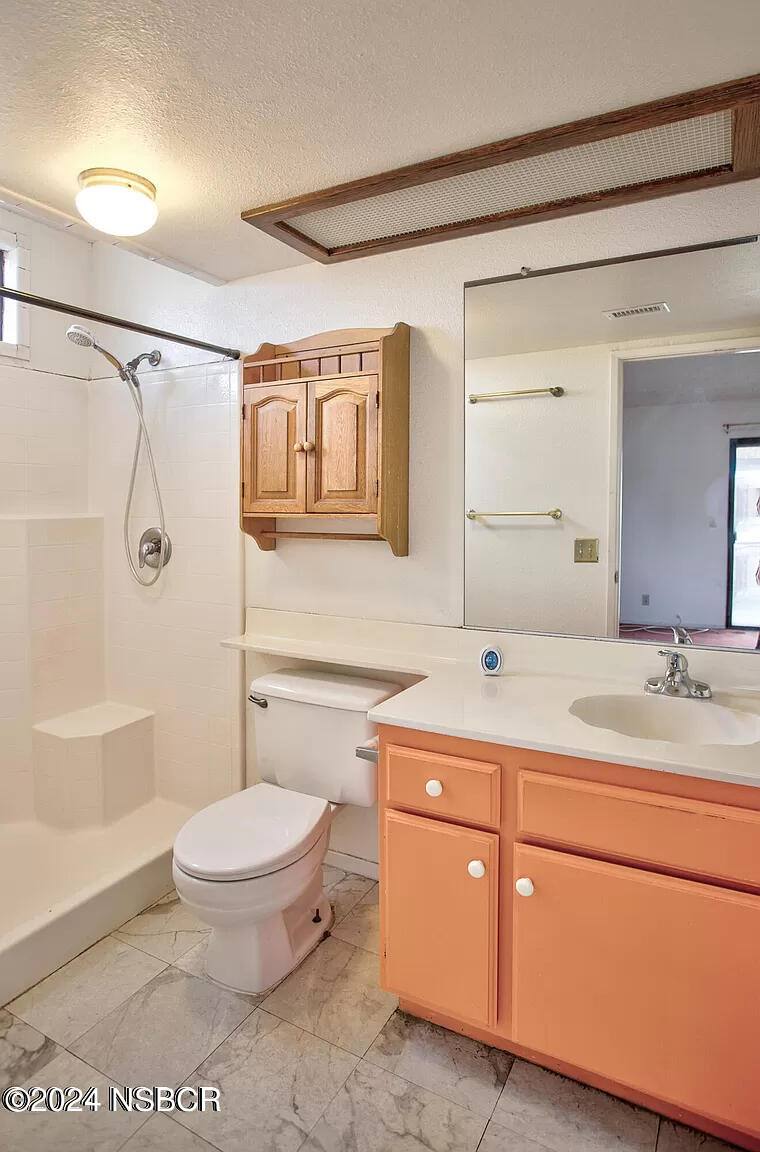 1352 Viola Way Lompoc, CA 93436 - Photo 15 of 30 a bathroom with a granite countertop sink a toilet and a bathtub