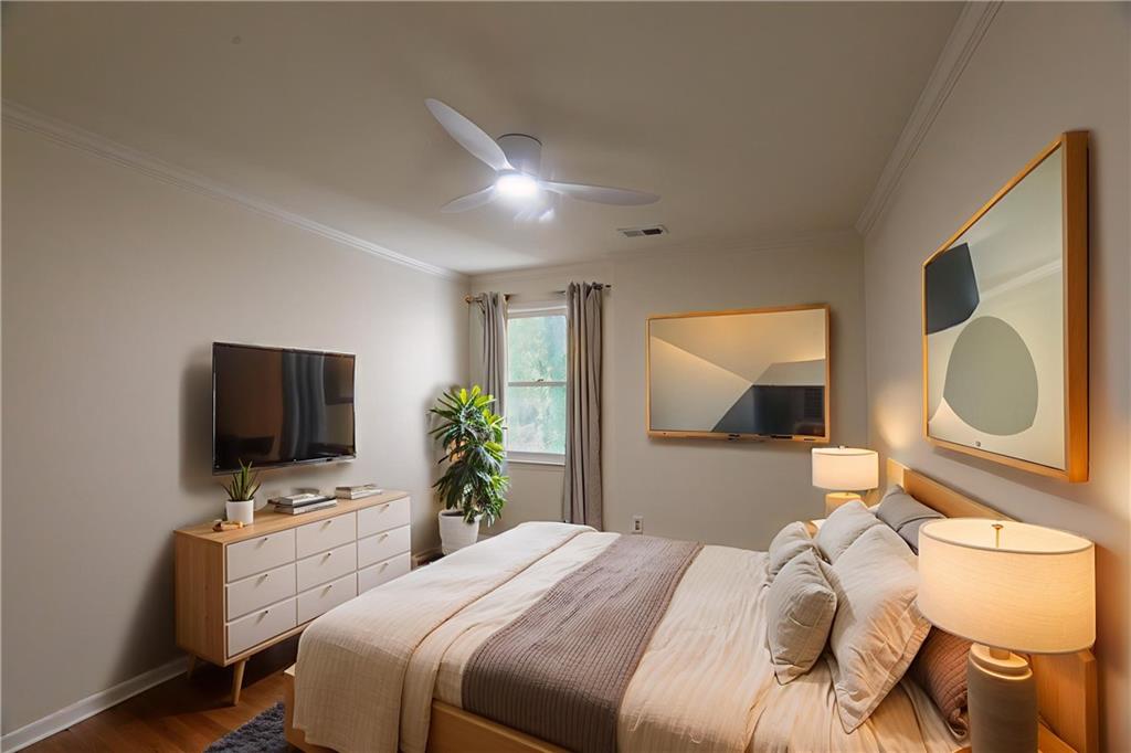 45 St Claire Lane Northeast Atlanta, GA 30324 - Photo 12 of 29 a bedroom with a bed and a flat screen tv