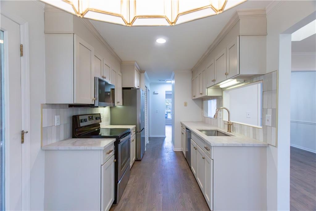 45 St Claire Lane Northeast Atlanta, GA 30324 - Photo 17 of 29 a kitchen with cabinets and wooden floor
