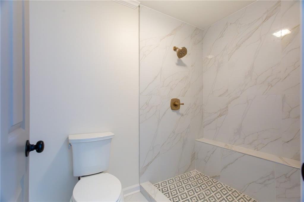 45 St Claire Lane Northeast Atlanta, GA 30324 - Photo 27 of 29 a bathroom with a toilet and shower