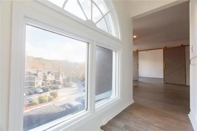 a view of a glass door with wooden floor