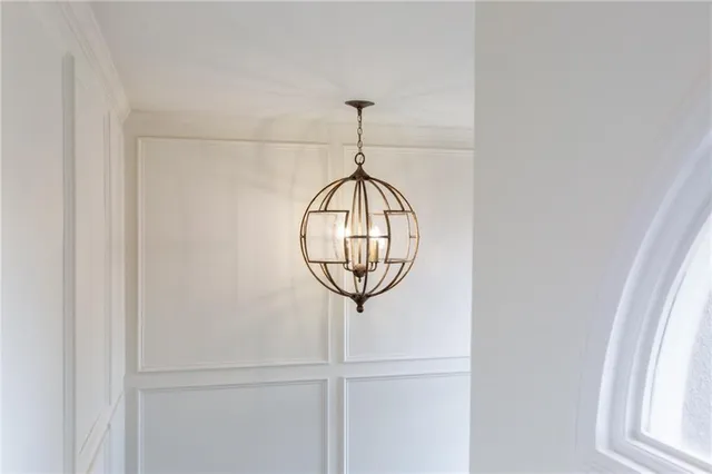 a view of a hallway with window and a chandelier